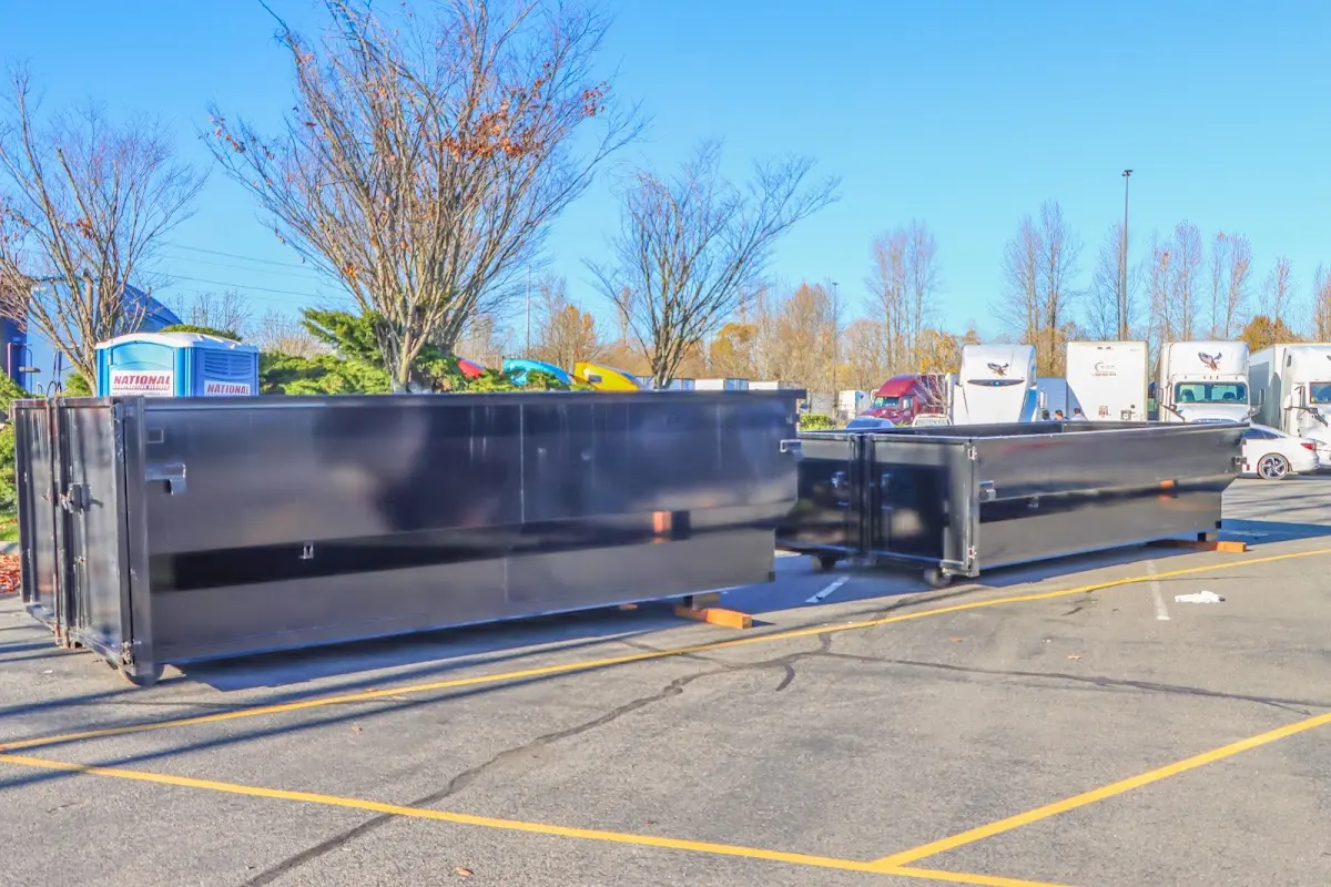 Professional dumpster rental service with roll-off container on residential driveway in Boca Raton